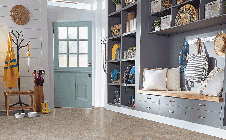luxury vinyl tile flooring in entryway with shoe storage